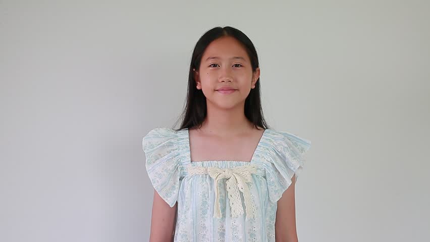 Beautiful Asian young girl pay respect or pray posture on white isolated studio background.