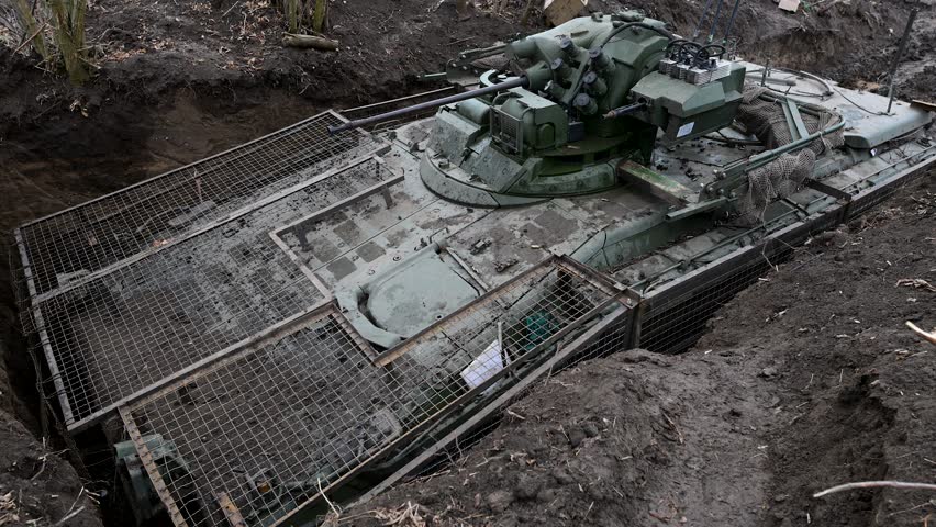 Modern Russian armor in Ukraine: This is a BMD-4M fighting vehicle in a dug-in position, equipped with a field-modified 