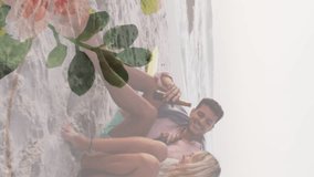Animation of diverse couple embracing on beach over flowers. Holidays, free time and digital interface concept digitally generated video. - Powered by Shutterstock - Get 15% off with code: PIKWIZARD15