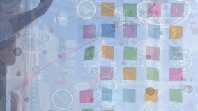 Animation of icons and graphs over diverse businesswoman and businessman talking in office. Business, finance and working in office concept digitally generated video. - Powered by Shutterstock - Get 15% off with code: PIKWIZARD15