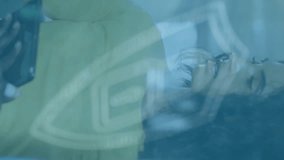 Animation of dots forming padlock in shield over diverse coworkers discussing in office. Digital composite, multiple exposure, business, protection, teamwork, planning and security concept. - Powered by Shutterstock - Get 15% off with code: PIKWIZARD15