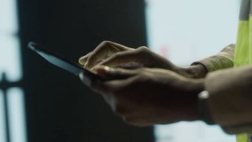 Professional engineer managing construction project, using digital tablet for reviewing blueprints and monitoring industrial site operations with focused precision - Powered by Shutterstock - Get 15% off with code: PIKWIZARD15