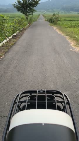 Footage of riding an electric bike in the middle of a soybean field in countryside