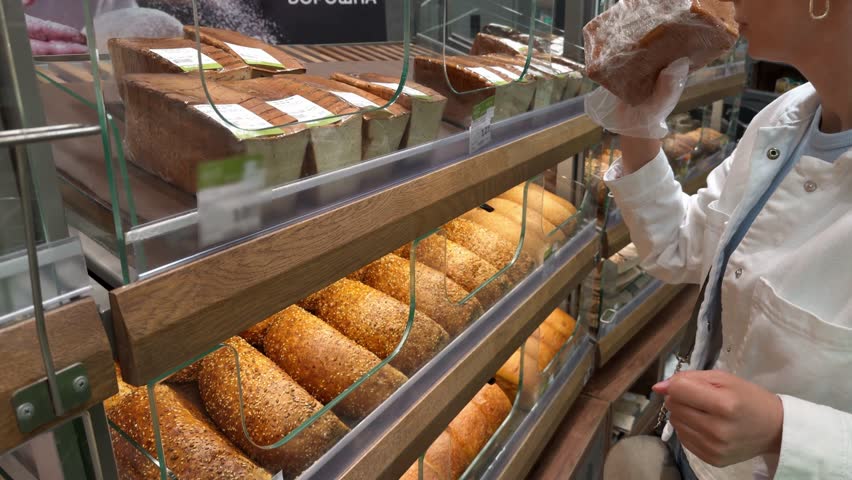 Freshly baked bread at bakery counter. Healthy multigrain bread and whole wheat loaves. Select artisan baked goods. Traditional baking culinary craftsmanship fresh food bread. Baked bread assortment