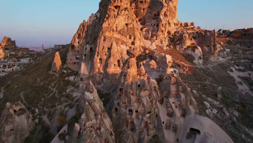 Aerial evening view Ancient Uchisar castle, underground city of Cappadocia Turkey, Goreme national park.