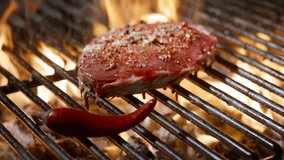 Ribeye Steak with Chili Pepper and Herbs on Hot Gril. Fire and Flavor - Powered by Shutterstock - Get 15% off with code: PIKWIZARD15