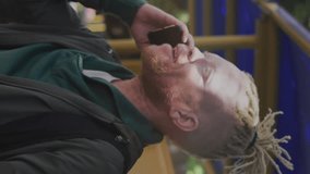 Animation of graphs, globes, map over albino african american man talking on cellphone. Computer language, digital composite, report, business, globalization, coding and technology concept. - Powered by Shutterstock - Get 15% off with code: PIKWIZARD15