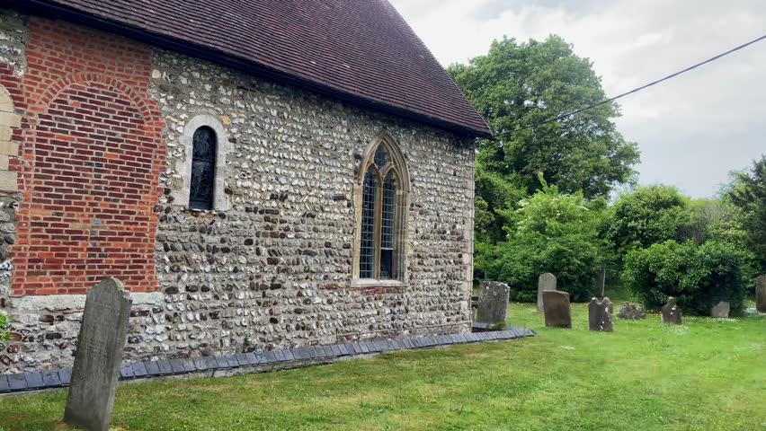 Historic church and cemetery in an old village in Kent, England. Clip 1