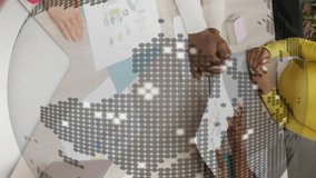 Diverse team collaborating at table with digital globe animation overlay. Teamwork, collaboration, innovation, technology, office, brainstorming - Powered by Shutterstock - Get 15% off with code: PIKWIZARD15