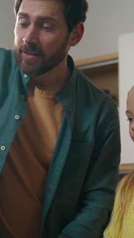 Caucasian family at kitchen unpacking delivery service eco shopping bag smiling father dad little child girl kid happy daughter unpack products vitamin jam orange juice bottle milk vegetables buying