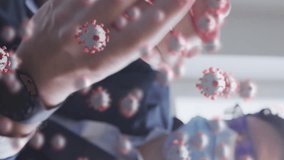 Animation of covid 19 cells floating over man wearing face mask, sanitizing his hands in office. Healthcare and protection during coronavirus covid 19 pandemic, digitally generated video. - Powered by Shutterstock - Get 15% off with code: PIKWIZARD15