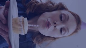 Animation of caucasian woman blowing candle on birthday cupcake and data processing. Global celebration, computing, digital interface and data processing concept digitally generated video. - Powered by Shutterstock - Get 15% off with code: PIKWIZARD15