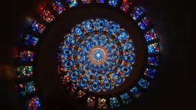 Looking up at a magnificent circular stained glass ceiling with a vibrant, intricate mandala design, creating a colorful and spiritual ambiance. - Powered by Shutterstock - Get 15% off with code: PIKWIZARD15
