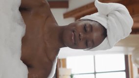 Animation of gold confetti falling over happy african american woman relaxing in bath at home. relaxation, health and wellbeing celebration concept digitally generated video. - Powered by Shutterstock - Get 15% off with code: PIKWIZARD15