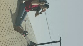 Two globes of digital icons against african american woman using smartphone sitting on the street. global networking and technology concept - Powered by Shutterstock - Get 15% off with code: PIKWIZARD15