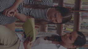 Animation of icons of school items moving over female teacher and schoolgirl talking and reading book in library in background. Education back to school and schooling concept digital composite. - Powered by Shutterstock - Get 15% off with code: PIKWIZARD15