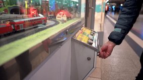 Hand touching a button control to activate a miniature model of a train station at Duisburg's main train station, Germany - Powered by Shutterstock - Get 15% off with code: PIKWIZARD15