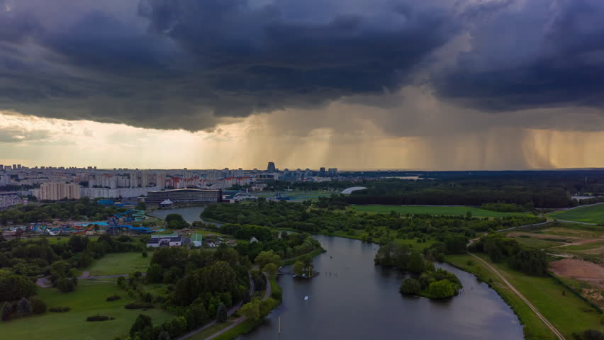 sunset sky storm rain clouds minsk city famous modern hotel riverside aerial panorama 4k timelapse belarus