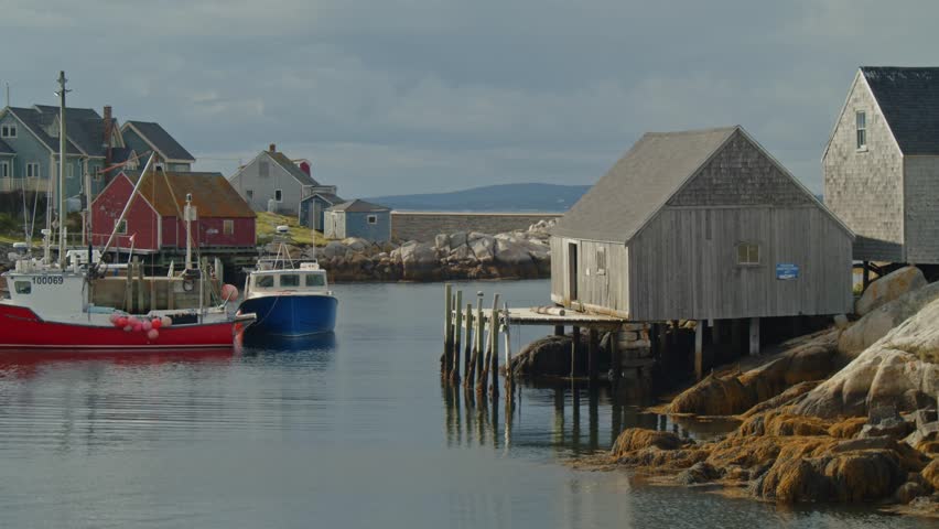 Known For Its Stunning Lighthouse, Peggys Cove Is A Picturesque Seaside Destination In Nova Scotia Where Tourists Enjoy Serene Views, Crashing Waves, And Coastal Walks Along Rocky Cliffs