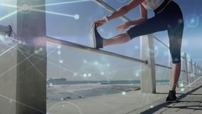 Woman approaching seaside railing, stretching hamstring for fitness with digital overlay floating. Fitness, outdoor, activewear, wellness, landscape, vitality, recreation - Powered by Shutterstock - Get 15% off with code: PIKWIZARD15