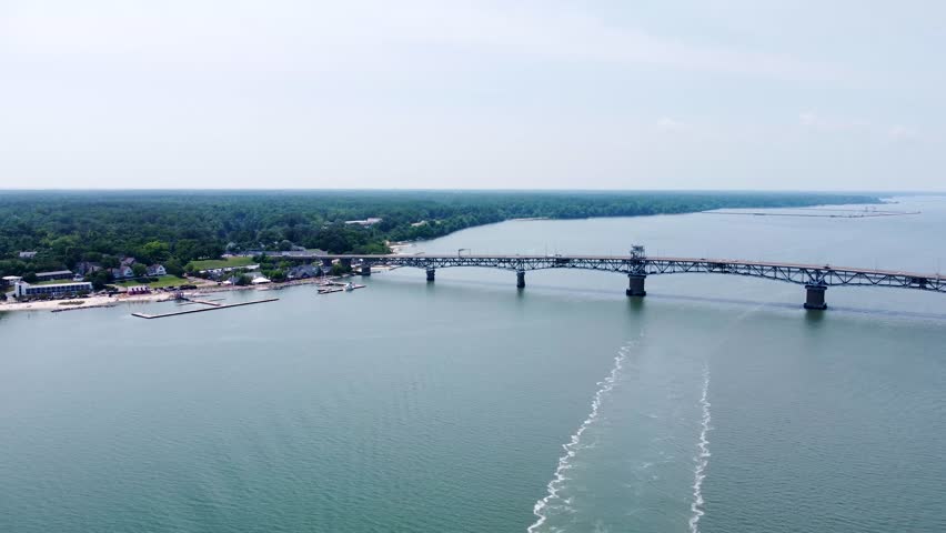 Aerial cinematic video of downtown Yorktown Virginia and the Coleman Bridge spanning the York River.