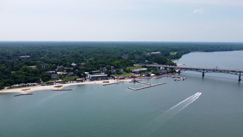 Aerial cinematic video of downtown Yorktown Virginia and the Coleman Bridge spanning the York River.