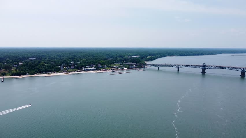 Aerial cinematic video of downtown Yorktown Virginia and the Coleman Bridge spanning the York River.