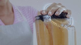 woman pressing lid on blender, activating smart blending with overlay of charts rising then fading. Technology, innovation, digital interface, kitchen, health, food prep, modern - Powered by Shutterstock - Get 15% off with code: PIKWIZARD15
