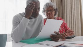 Couple furrowing brow and raising concern over finance document, tapping phone with animated data. Family, seniors, discussion, technology, communication, domestic, contemplation - Powered by Shutterstock - Get 15% off with code: PIKWIZARD15