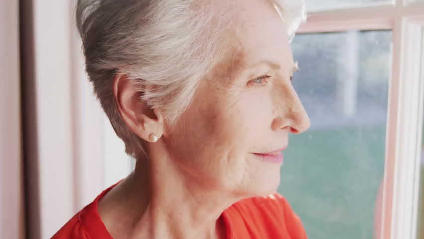 Senior female gazing by window activating health tech facial mapping overlay scanning skin contours. Elderly, technology, health, analytics, biometric, digital, wellness - Powered by Shutterstock - Get 15% off with code: PIKWIZARD15