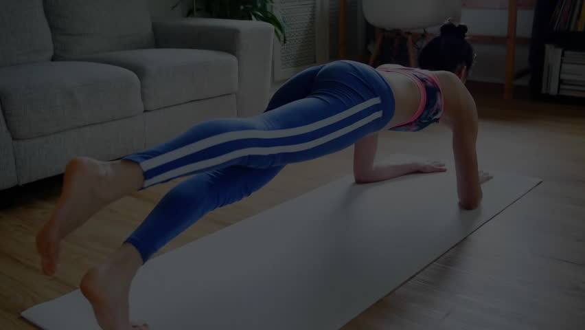 Fitness trainer shifting weight to right hand entering side plank and lifting leg for core toning. Exercise, wellness, strength, balance, training, home fitness, dynamic