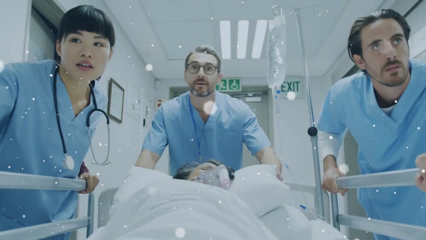 Medics pushing stretcher along corridor adjusting oxygen mask, IV in crisis with drifting particles. Emergency, healthcare, teamwork, professionalism, hospital, urgency, medical