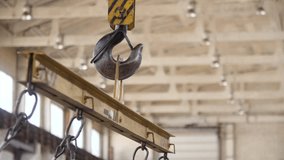 Industrial crane hook hangs in industrial workshop. Lifting equipment for heavy metal materials in metalworking factory. Heavy industry concept. Metal products manufacturing, metallurgy plant. - Powered by Shutterstock - Get 15% off with code: PIKWIZARD15