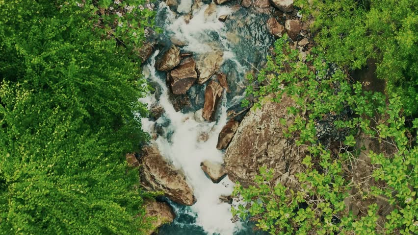 mountain stream drone, rocky creek view, clear water flow, 4k mountain creek, cinematic river scene, peaceful alpine stream, nature creek footage, flowing river rocks, scenic stream aerial