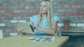 female analyst tapping tablet screen initiating stock chart overlays and reviewing market data. Modern, professional, rustic, digital, finance, workspace, concentration - Powered by Shutterstock - Get 15% off with code: PIKWIZARD15