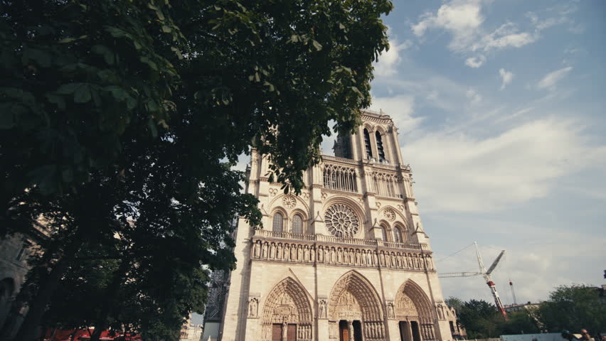Scenic view of Notre Dame cathedral in Paris France showing medieval gothic architecture and surrounding historical cityscape in the European tourist district