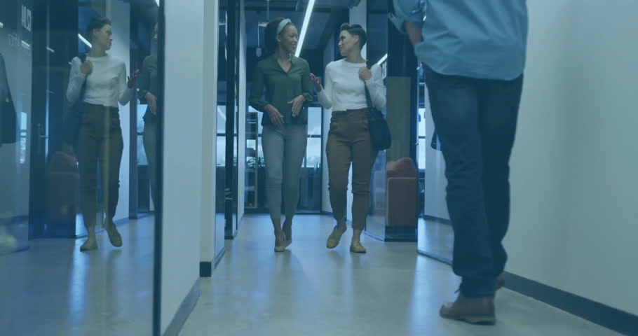 Two female colleagues walking as overlays morph into world map explaining metrics to coworker. Business, teamwork, analytics, data visualization, professional, corporate, innovation