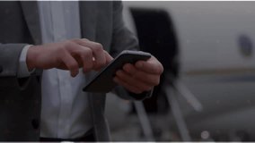 Business traveler tapping smartphone on tarmac, activating scan circle showing past travel timeline. Technology, connectivity, digital, navigation, aviation, professional, modern - Powered by Shutterstock - Get 15% off with code: PIKWIZARD15