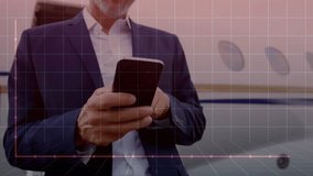 Mature businessman tapping smartphone beside private jet, animating pink line graph showing decline. Corporate, innovation, technology, aviation, finance, analysis, futurism - Powered by Shutterstock - Get 15% off with code: PIKWIZARD15