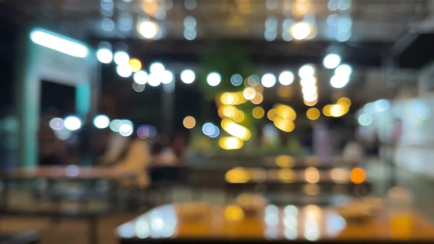 defocused night scene of modern cafe with warm bokeh lights