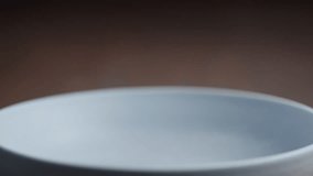 Slow motion pesto fusilli poured in blue bowl - Powered by Shutterstock - Get 15% off with code: PIKWIZARD15