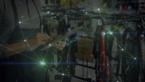 Male bicycle technician tapping tablet and reviewing retail bike inventory with network overlays. Technology, retail, industry, service, consultation, innovation, digital - Powered by Shutterstock - Get 15% off with code: PIKWIZARD15