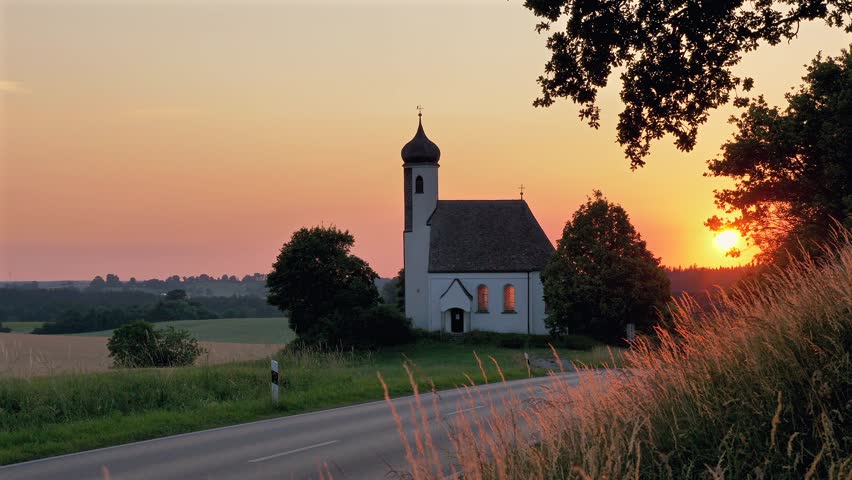 Small church, chapel on a country road towards the evening sun, Bavaria, Germany, Europe