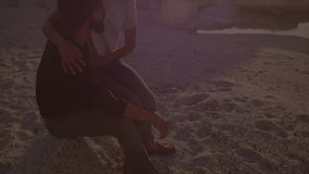Film showing couple hugging beach near tide pool at sunset, sparking glowing fractal light overlay. Romance, affection, connection, serenity, warmth, intimacy, landscape - Powered by Shutterstock - Get 15% off with code: PIKWIZARD15