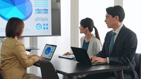 A group of business people having a meeting while looking at a large screen monitor - Powered by Shutterstock - Get 15% off with code: PIKWIZARD15