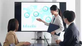 A group of business people having a meeting in front of a large screen monitor - Powered by Shutterstock - Get 15% off with code: PIKWIZARD15