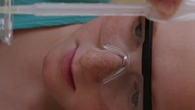 Animation of glowing lights over caucasian girl with pipette and chemistry beaker. Science and learning concept digitally generated video. - Powered by Shutterstock - Get 15% off with code: PIKWIZARD15