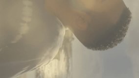 Animation of lens flares over diverse couple embracing and kissing on beach against sea and sky. Digital composite, multiple exposure, love, togetherness, happiness, vacation and romance concept. - Powered by Shutterstock - Get 15% off with code: PIKWIZARD15