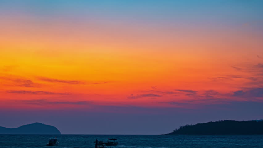 Time lapse Floating Serenity at Sunrise
Under a radiant sunrise sky, small boats drift quietly across glassy tropical waters. The vibrant colors of dawn dance across the sea, creating a peaceful