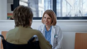 Elderly patient in wheelchair talking with female physician. - Powered by Shutterstock - Get 15% off with code: PIKWIZARD15